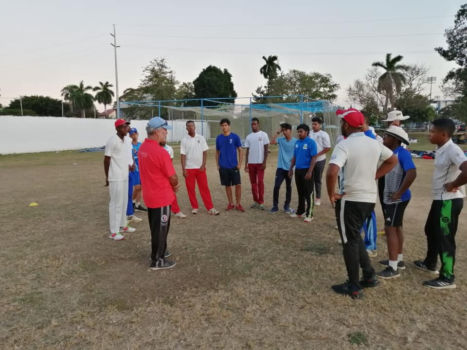 Coach Gregory Davis speaks with U19 players at a training session at St. Mary's College.